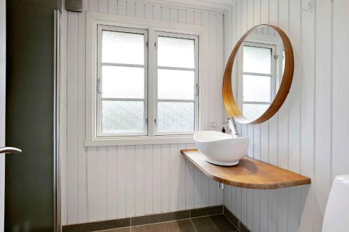 a bathroom with a sink and a mirror at Nyistandsat sommerhus med kærlighed og sjæl in Kyndeløse