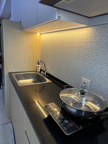 a kitchen counter with a sink and a bowl on it at One bedroom apartment at Borneo Bay City in Klandasan Kecil