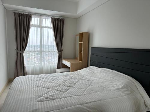 En eller flere senge i et værelse på One bedroom apartment at Borneo Bay City