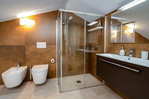 a bathroom with a shower and a toilet and a sink at Riviera degli Ulivi - Terrace over the castle in Torri del Benaco