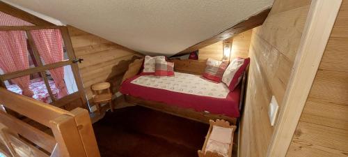 Una cama pequeña en una casa diminuta en una habitación. en Bal2502, en Manigod