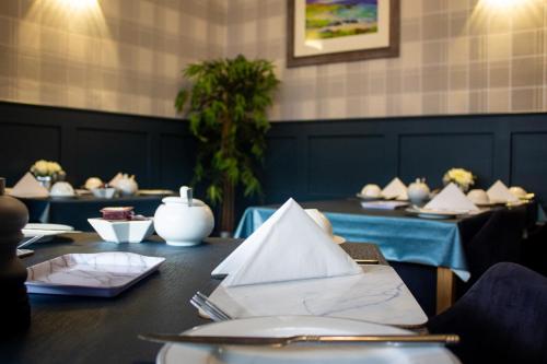 a dining room with a table with papers on it at Kintrae B&B in Buckie