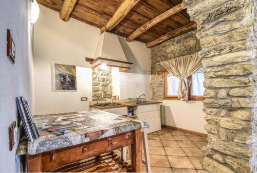 a kitchen with a counter and a stone wall at Romantic Boutique Hospitality in Revine Lago