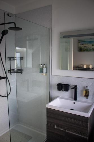 a bathroom with a sink and a shower at Kintrae B&B in Buckie