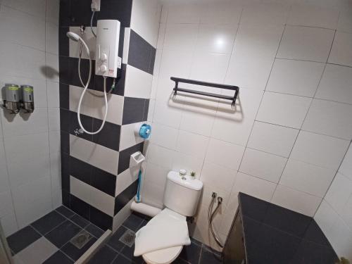 a bathroom with a shower and a toilet in it at SY Staycation - Studio with Netflix in Bayan Lepas