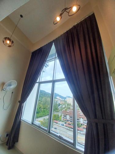 a large window with a view of a city at SY Staycation - Studio in Bayan Lepas