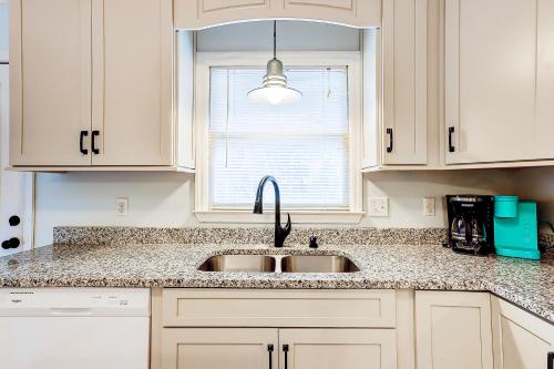 a kitchen with a sink and a window at Geechee Girl in Edisto Beach
