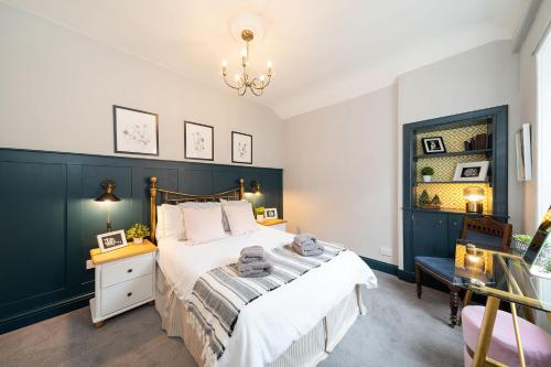 a bedroom with a large bed and a chandelier at Heritage Quarter in Fife