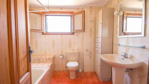 a bathroom with a toilet and a sink and a tub at Na Penyal Ref 246 in Cala Millor