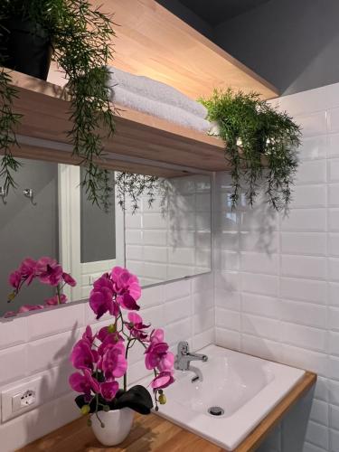 ein Badezimmer mit einem Waschbecken mit rosa Blumen darauf in der Unterkunft BRIC NEST il luogo ideale per la tua vacanza. in Florenz
