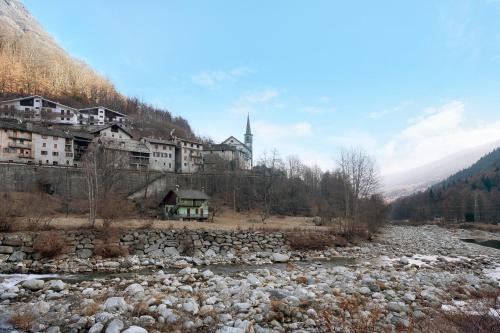 a town on a hill next to a river at Casa Gianpaolo in Piode