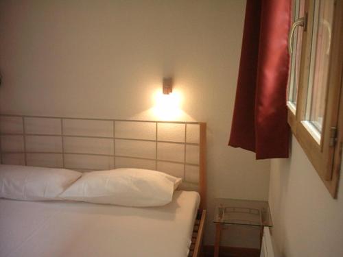 En eller flere senger på et rom på Appartement Valfréjus, 2 pièces, 4 personnes - FR-1-265-206