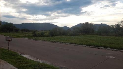 an empty road with mountains in the distance at La Trinidad San Luis, La Punta in La Punta