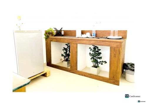 a wooden table with two plants inside of it at Ayona Beach Villa in Katuneriya