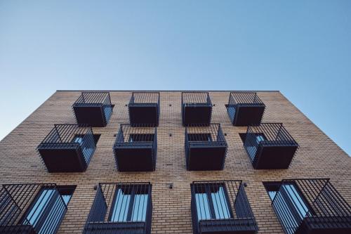 a tall brick building with several windows on it at Hotel O Guerreiro in Ponte da Barca