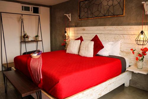 a bedroom with a red bed with a red blanket at Casa Flora Handmade Hotel in Atlixco