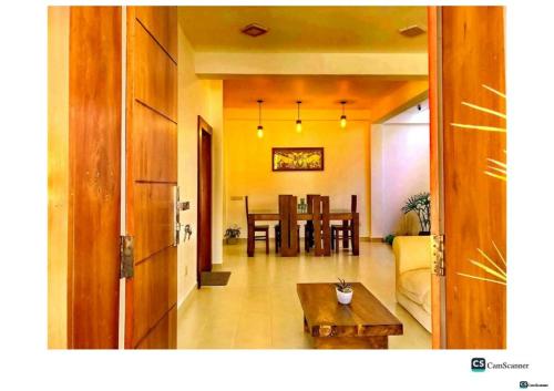 a living room with a couch and a table at Ayona Beach Villa in Katuneriya