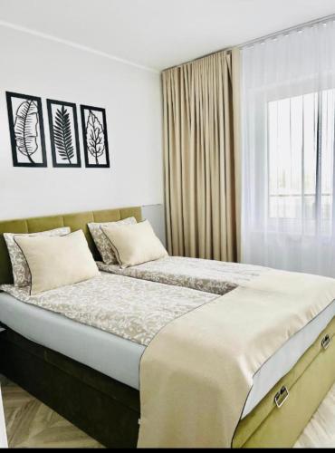 a bedroom with two beds and a window at ApartCentrum-CHARLOTTE -PARKING-Air conditioning in Bolesławiec