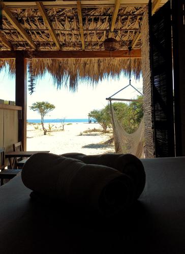 a hammock on a beach with a view of the ocean at Casa Gitana in Chamuscadero