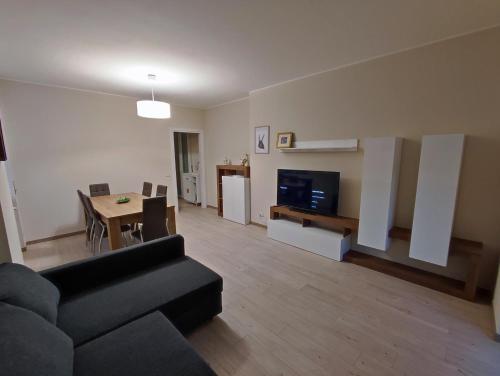 a living room with a couch and a table and a television at Residenza al Lago in Germignaga