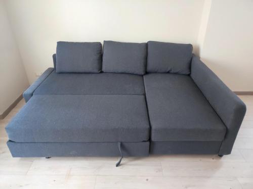a blue couch sitting in a room at Residenza al Lago in Germignaga