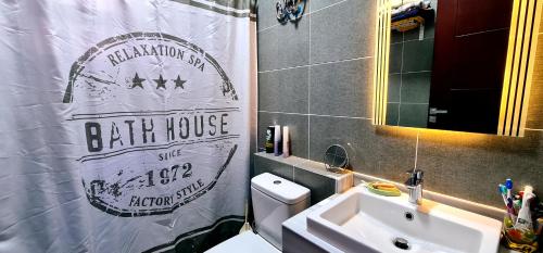 a bathroom with a sink and a toilet and a shower curtain at Ain Sokhna 'Cosmopolitan' in Ain Sokhna