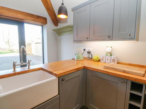 a kitchen with a sink and a window at The Byre, Sedbury Park Farm in Richmond