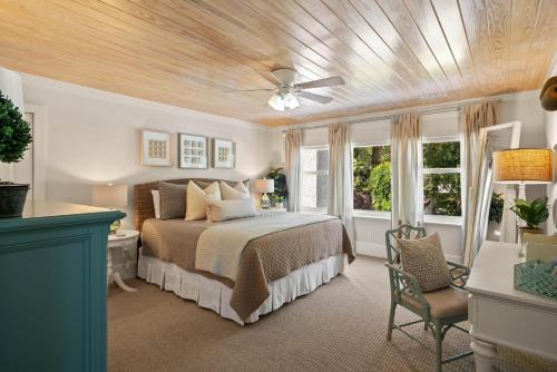 a bedroom with a bed and a ceiling fan at Anastasia’s Burrow - 629 Oak St in Demere Park
