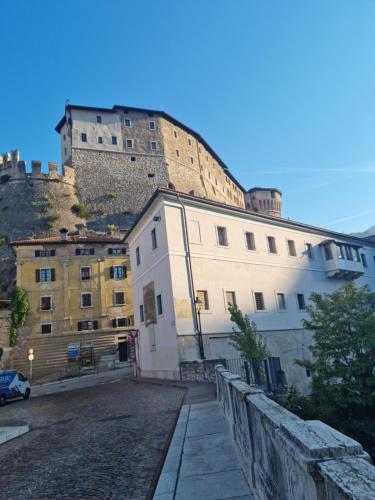a building with a castle on top of it at Apartments via Roma in Rovereto