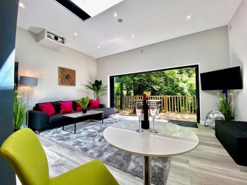 a living room with a couch and a table at Sunridge Cubes (Cube 2) in Plymouth