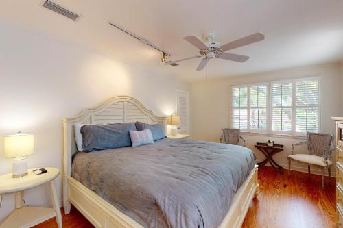 a bedroom with a bed and a ceiling fan at Latitude Adjustment - 4311 Ninth Street in Saint Simons Island