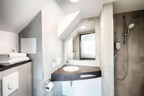 a bathroom with a sink and a shower at B&B Hotel Wien-Stadthalle in Vienna