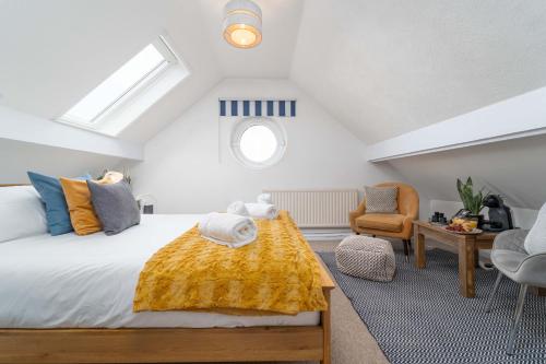 a bedroom with a bed with a yellow blanket on it at Number One - Stones Court in St Ives