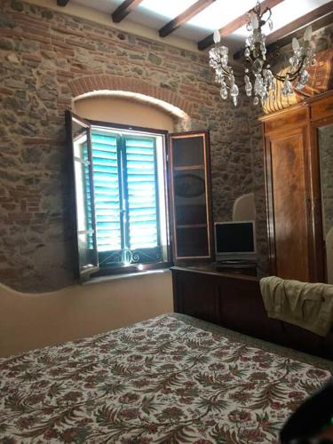 a bedroom with a bed and a window and a mirror at Ary's House -Profumo di salmastro in San Vincenzo