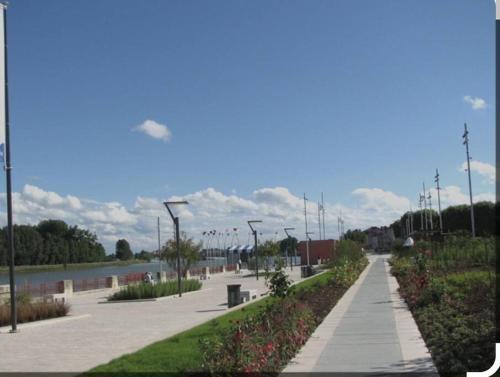 a walkway with a river and street lights in a park at Spa-Sauna-Ciel de pluie tropicale-Champagne Nuit Romantique - Escapade Mâconnaise in Mâcon