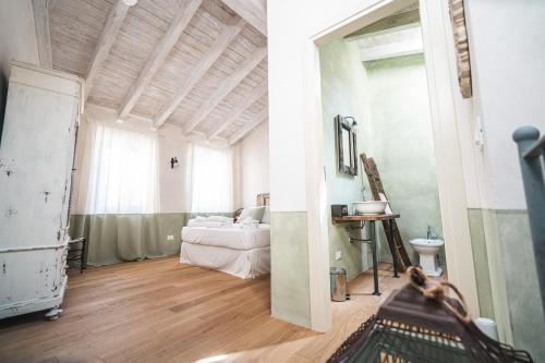 a bedroom with a bed and a table in a room at Borgo dei Gatti Albergo Diffuso in Golferenzo