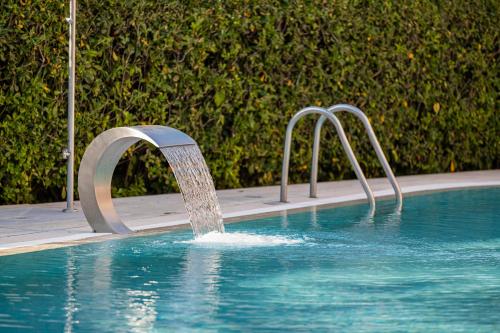 a water fountain in a swimming pool at Hotel Imperial ***S in Garda