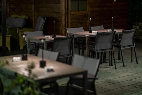 a row of tables and chairs in a patio at Hotel Imperial ***S in Garda