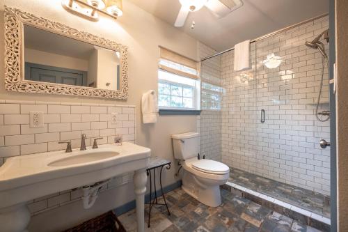 a bathroom with a sink and a toilet and a mirror at Quaint Countryside Casita 45 Mi to Ft Worth in Buckner