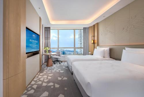 Ein Bett oder Betten in einem Zimmer der Unterkunft Shenzhenair International Hotel