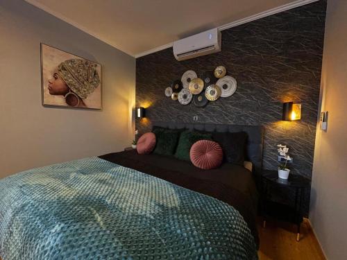 a bedroom with a bed with pillows and a wall at House vacation with pool,three rooms,near Šibenik in Planjane