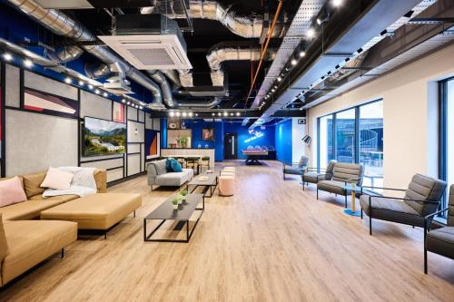 a living room with couches and chairs and tables at The Spireworks Oxford in Oxford