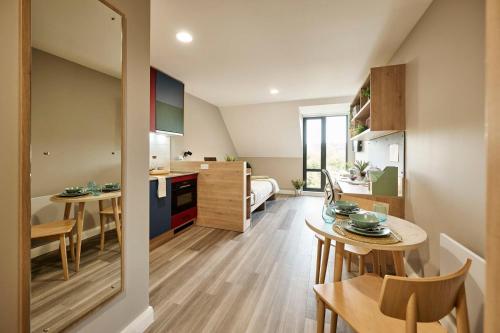 a kitchen and living room with a table and chairs at The Spireworks Oxford in Oxford