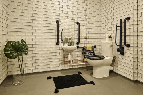 a bathroom with a toilet and a sink at The Spireworks Oxford in Oxford