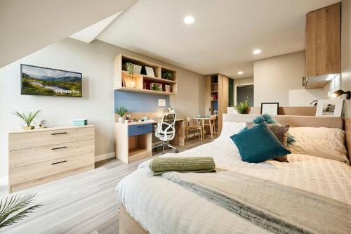 a bedroom with a bed and a desk in a room at The Spireworks Oxford in Oxford