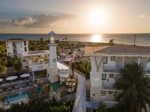 an aerial view of a resort with a lighthouse at Naay Boutique Hotel Holbox in Holbox Island