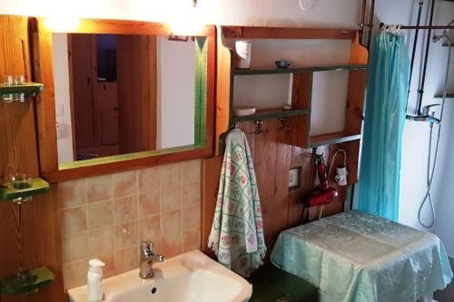 a bathroom with a sink and a mirror at MARIA'S Rustic stonehouse in traditional village in Koúmani