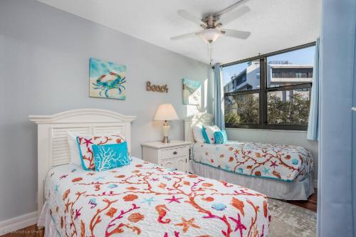 a bedroom with two beds and a window at Harbor Tower Intracoastal Condo in Siesta Key