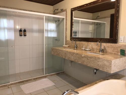 łazienka z 2 umywalkami i prysznicem w obiekcie Pousada Jambo w mieście Itacimirim