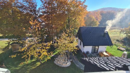 an overhead view of a small white house with a tree at B&B Plitvice Holiday Lodge in Plitvička Jezera